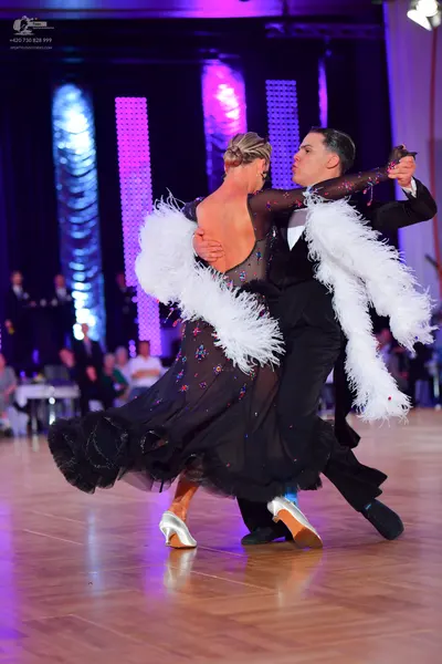Dancesport competitor: Male dancer: black suit with a white shirt