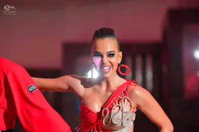 Dancesport competitor: Female dancer: red latin dress with silver/white sequin/beaded detailing and red