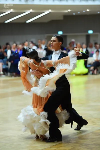 Dancesport competitor: Male dancer: black suit with a white shirt and white bowtie