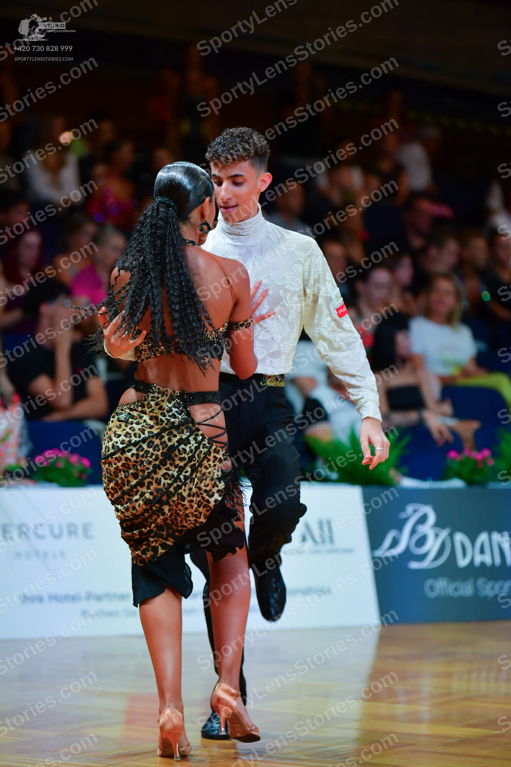 Dancesport competitor: Male dancer: white long-sleeved mock-neck shirt and black trousers