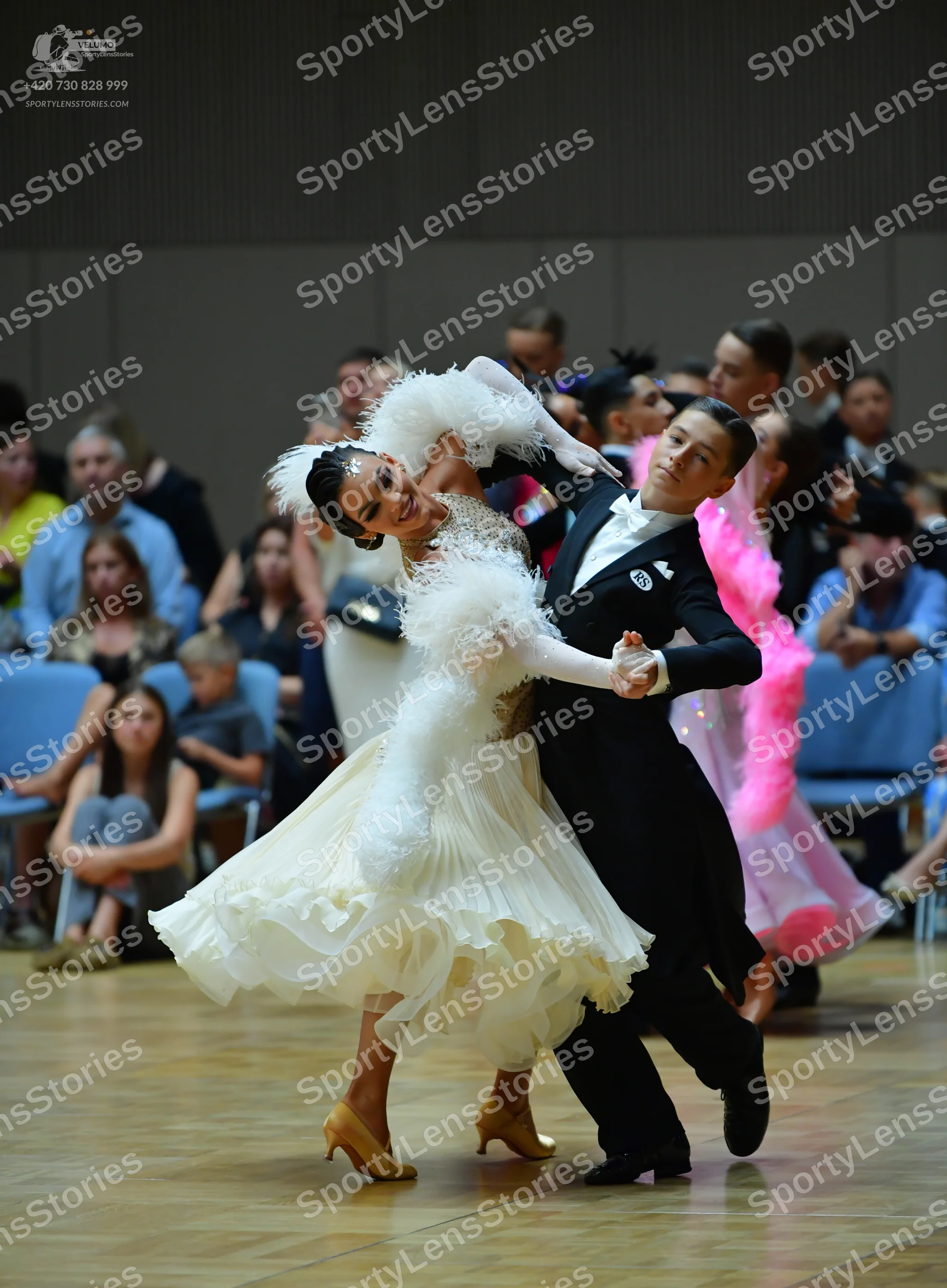 Dancesport competitor: Male dancer: black formal ballroom suit with a white shirt and white bowtie