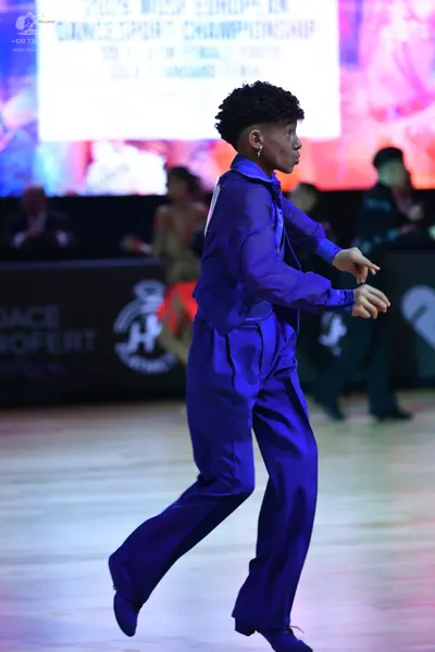 Dancesport competitor: Male dancer: blue satin long-sleeved shirt and matching trousers
