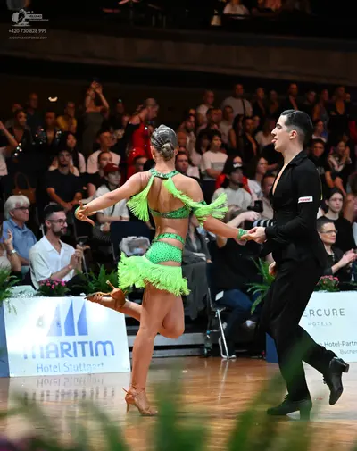 Dancesport competitor: Female dancer: bright lime green latin dance costume with fringe