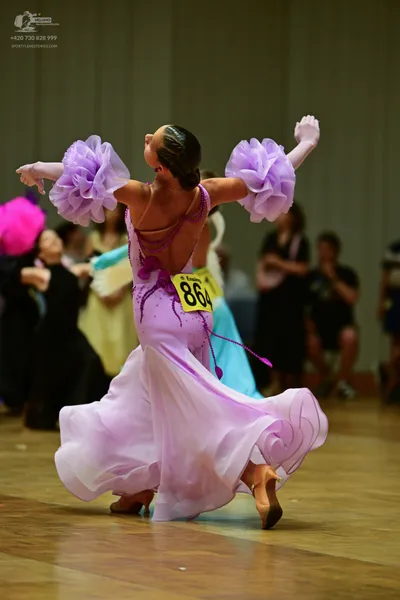 Dancesport competitor #864: Okay, let's break down the costumes of the dancers in this photo:

**Dancer 1 (C
