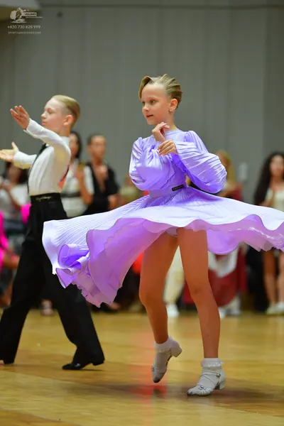 Dancesport competitor: Male dancer: white long-sleeved shirt, black tie, and black trousers