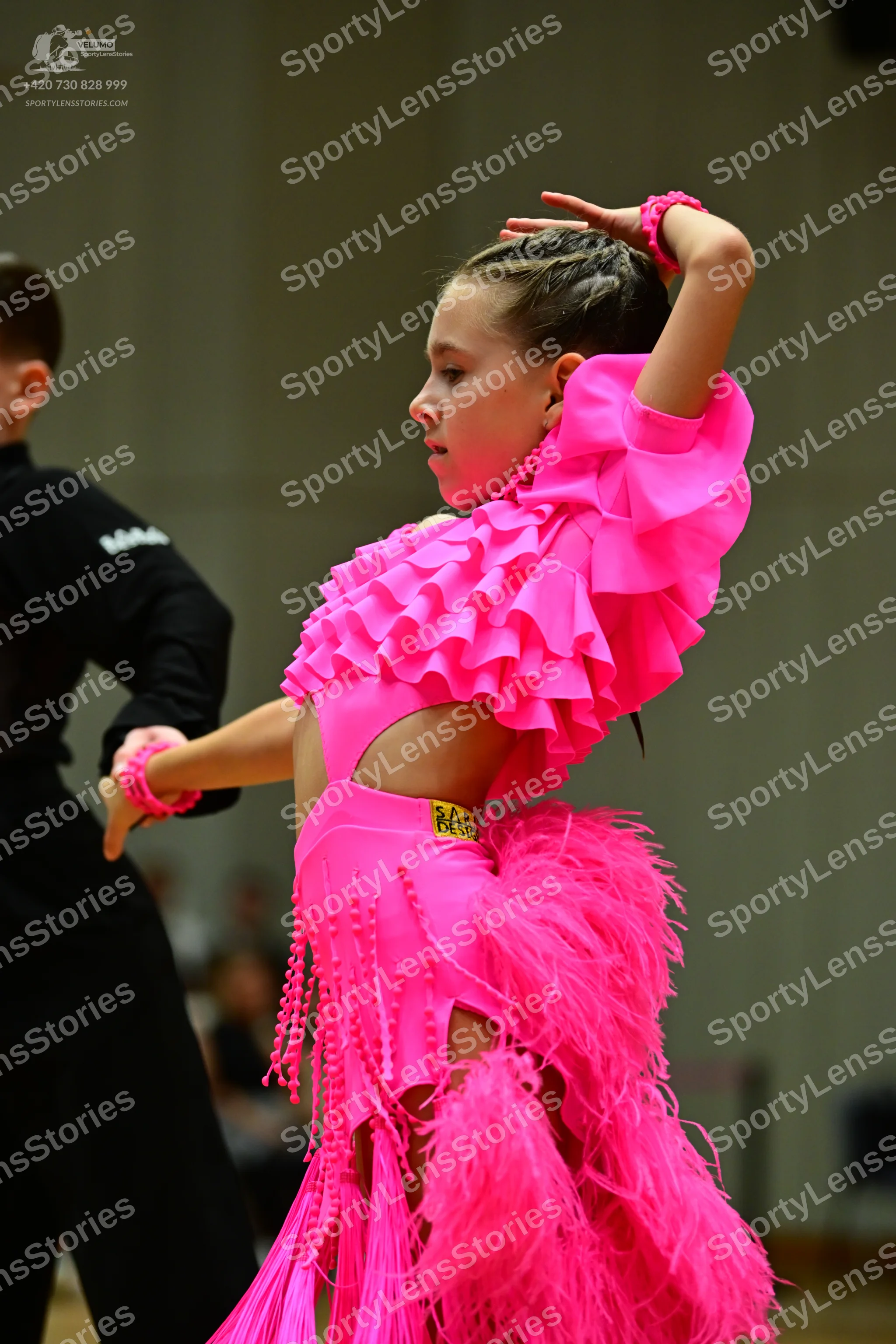 Dancesport competitor #88: Female dancer: bright pink Latin dress with ruffles, long pink fringe, pink feat