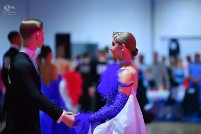 Dancesport competitor: Male dancer: black suit with a white shirt and white bow tie