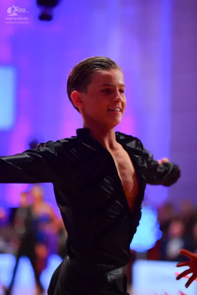 Dancesport competitor: Male dancer: black long-sleeved satin-like shirt and black trousers