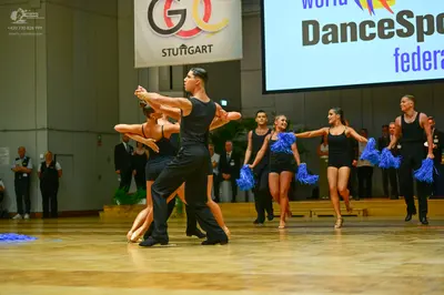 Dancesport competitor: Male dancers: black tank tops and black trousers