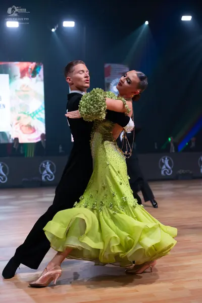 Dancesport competitor: Male dancer: black ballroom tailcoat, white shirt, and black bow tie