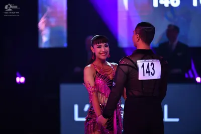 Dancesport competitor: Male dancer: black long-sleeved shirt and black pants