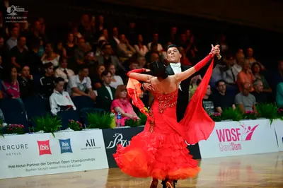 Dancesport competitor: Male dancer: black suit with a white shirt and a white bowtie