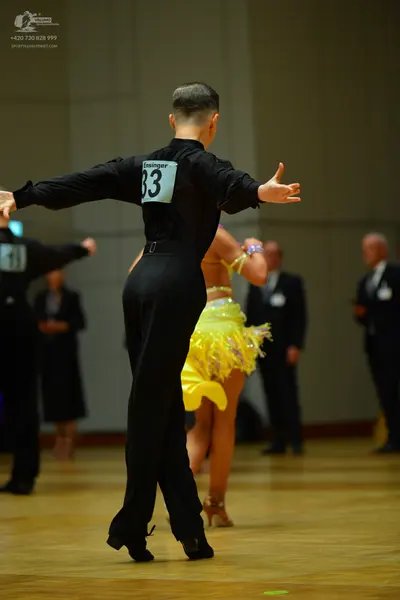 Dancesport competitor: Male dancer: black long-sleeved shirt and black trousers