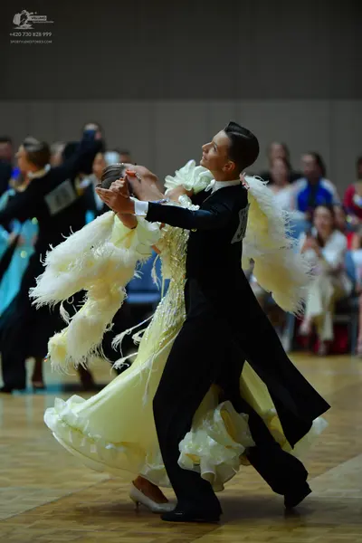 Dancesport competitor: Male dancer: black ballroom suit with a white shirt