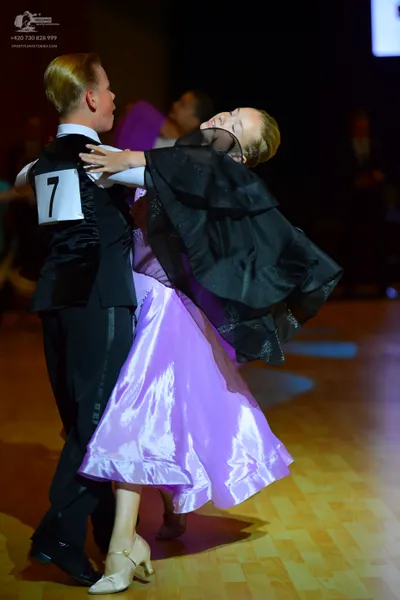 Dancesport competitor: Male dancer: black waistcoat, white shirt, and black trousers
