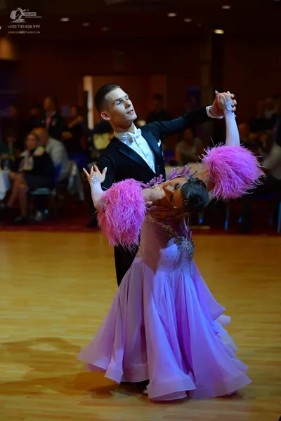 Dancesport competitor: Male dancer: black suit with a white shirt
