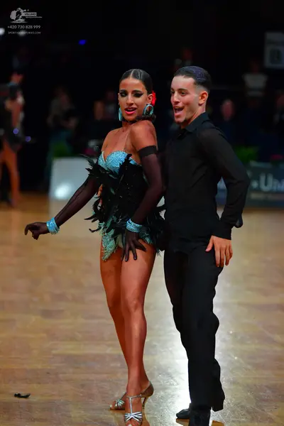 Dancesport competitor: Male dancer: black long-sleeved shirt and black trousers
