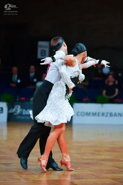 Dancesport competitor: Male dancer: white long-sleeved shirt and black trousers