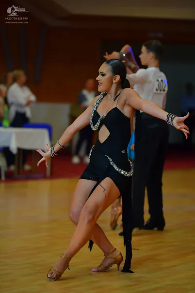 Dancesport competitor #302: Female dancer: black latin dress with silver sequin embellishments and matching 
