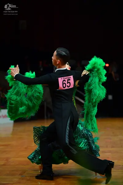 Dancesport competitor: Male dancer: black long-sleeved shirt and black trousers