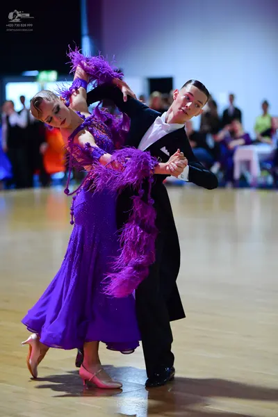 Dancesport competitor: Male dancer: black tailcoat, white shirt, white waistcoat, black trousers, and b
