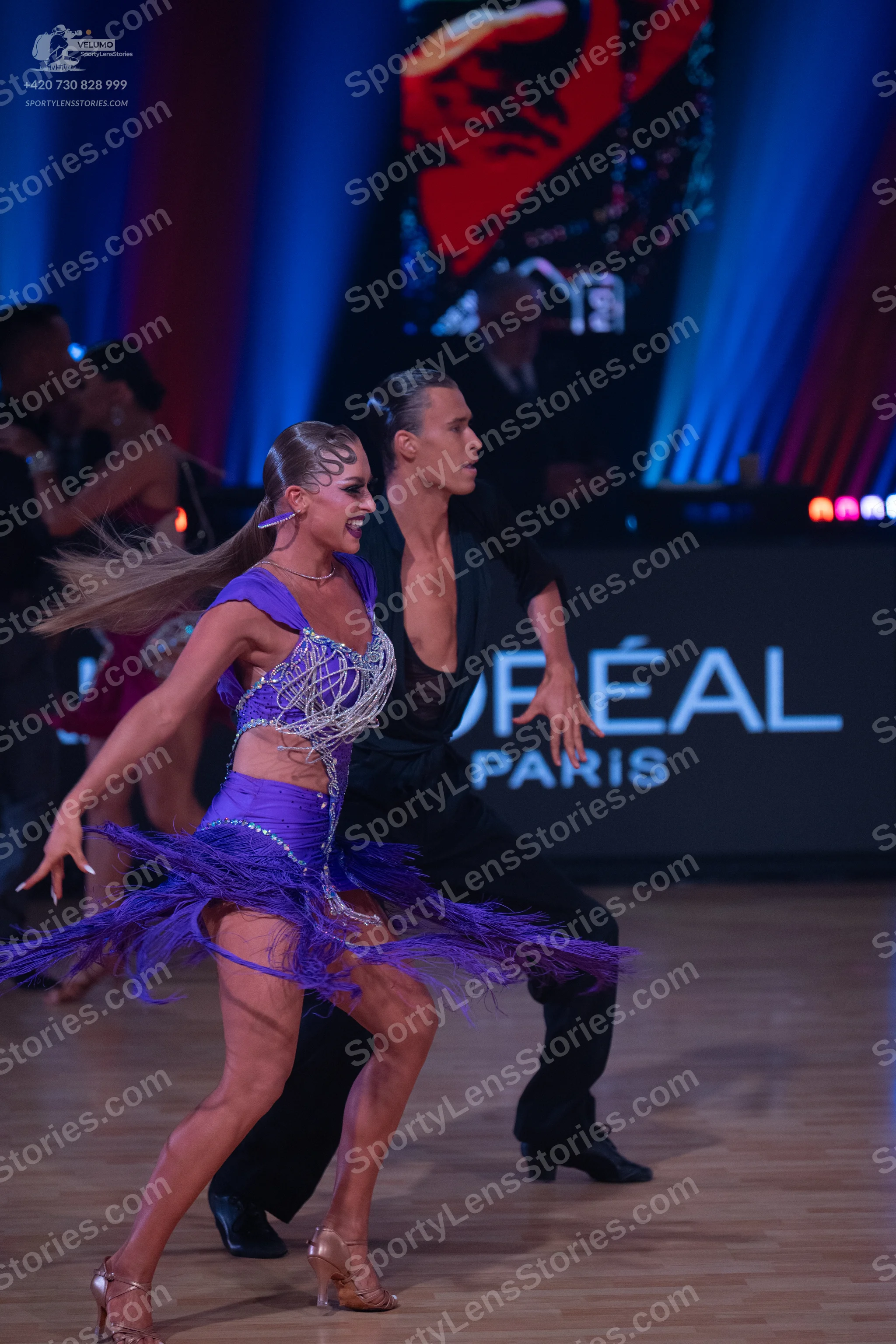 Dancesport competitor: Female dancer: purple Latin dress with sequins and fringe