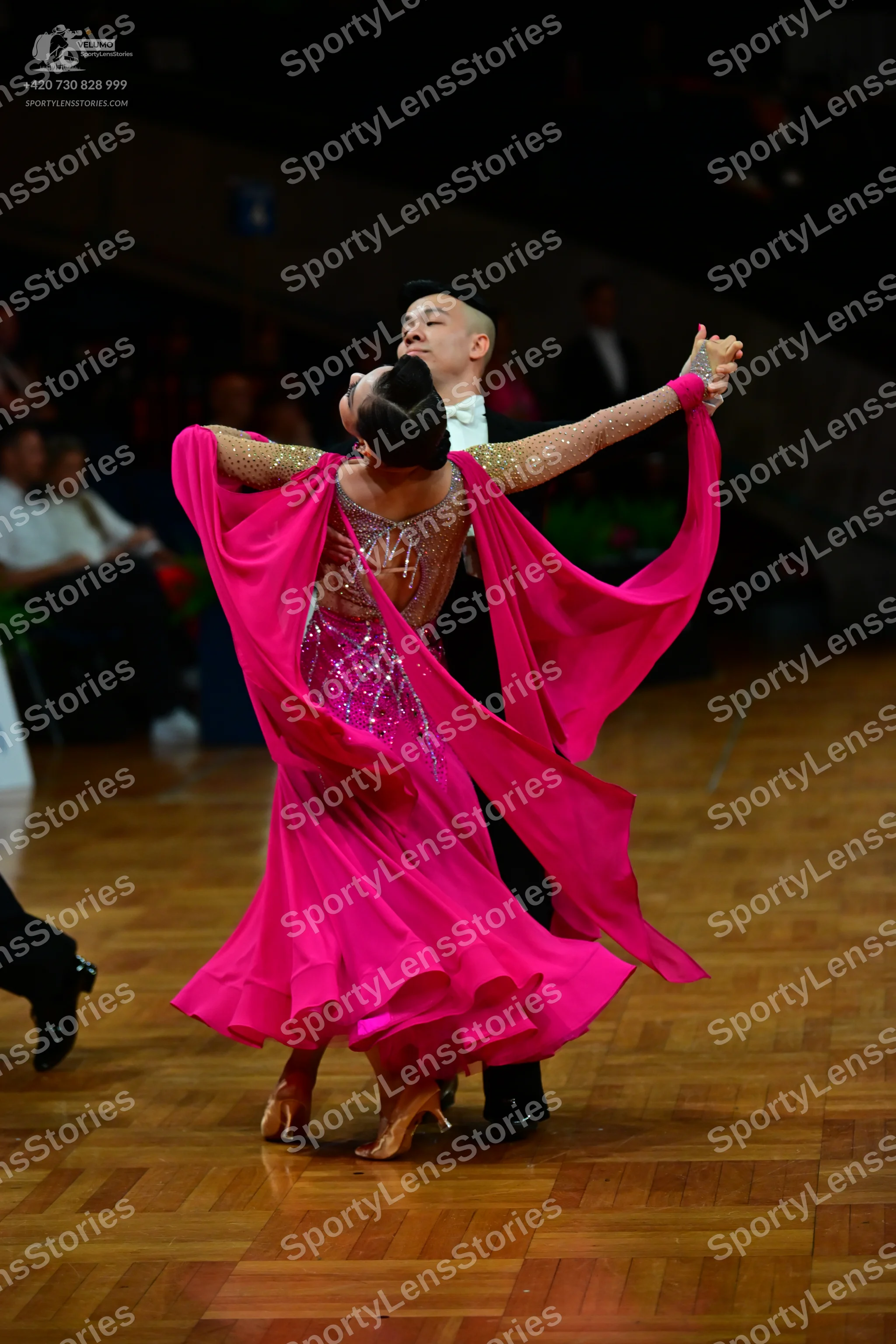 Dancesport competitor: Female dancer: bright pink ballroom dress with a heavily embellished bodice and