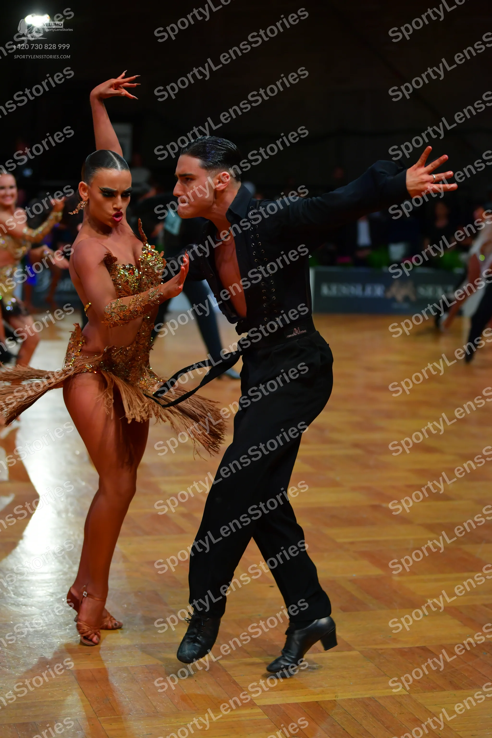 Dancesport competitor: Female dancer: gold latin dress with sequins and fringe