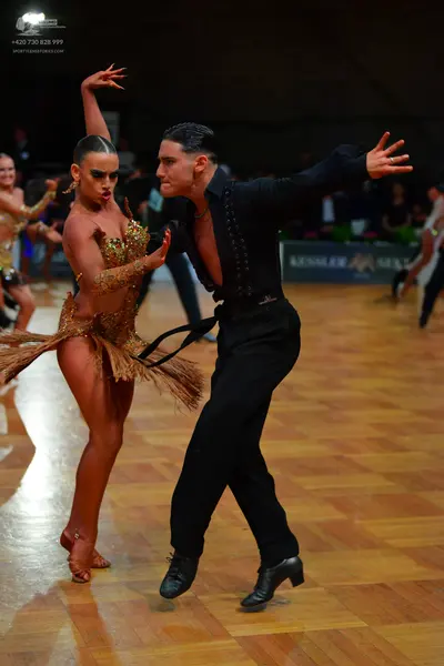 Dancesport competitor: Female dancer: gold latin dress with sequins and fringe