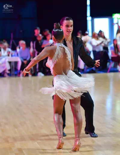 Dancesport competitor: Male dancer: black long-sleeved shirt and black trousers