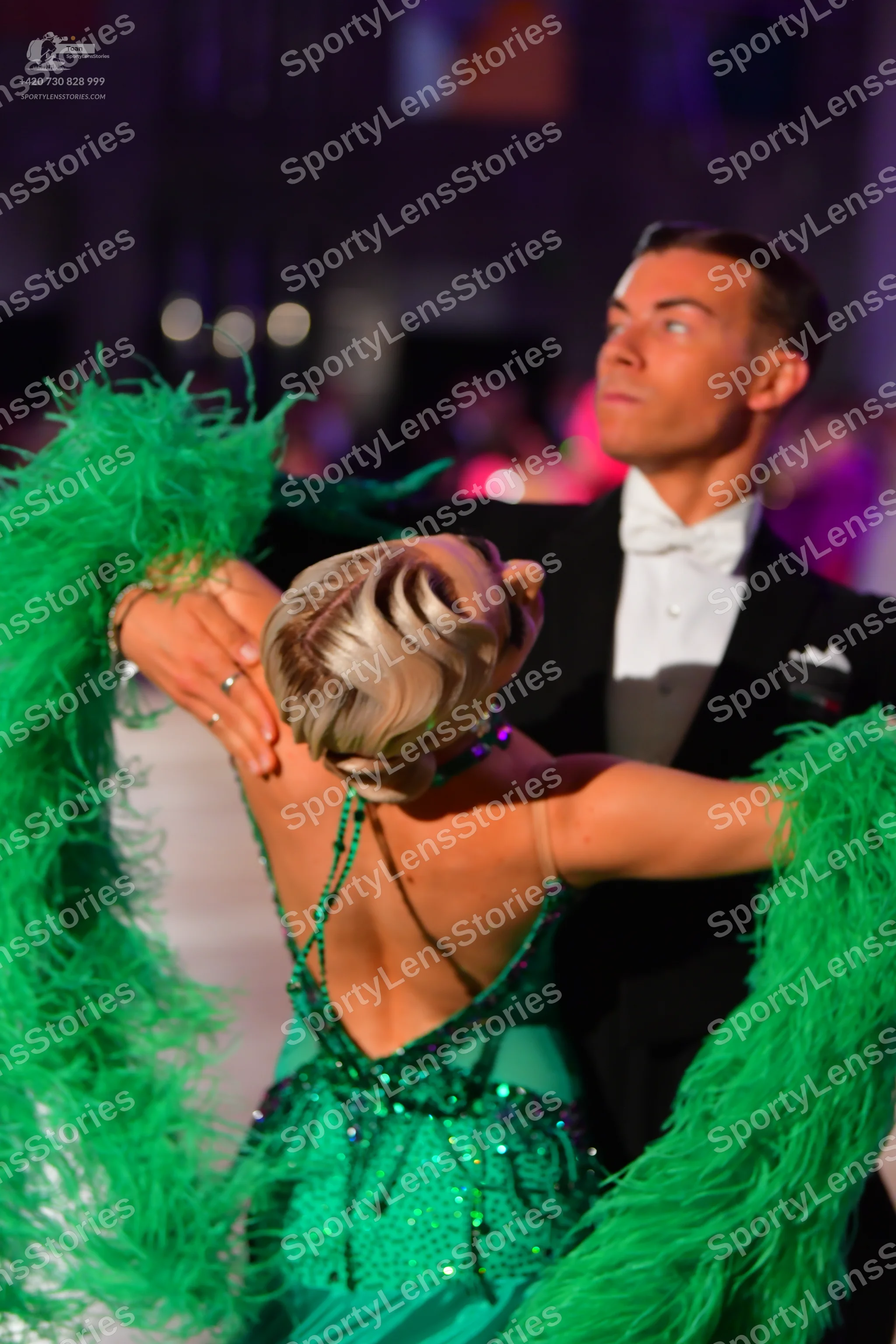 Dancesport competitor: Male dancer: black tuxedo with a white shirt, white bow tie, and a white pocket