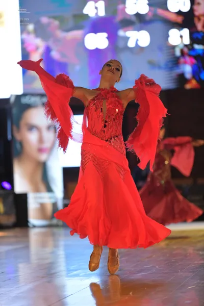 Dancesport competitor #41, #56: Female dancer: red latin dress with lace and fringe details