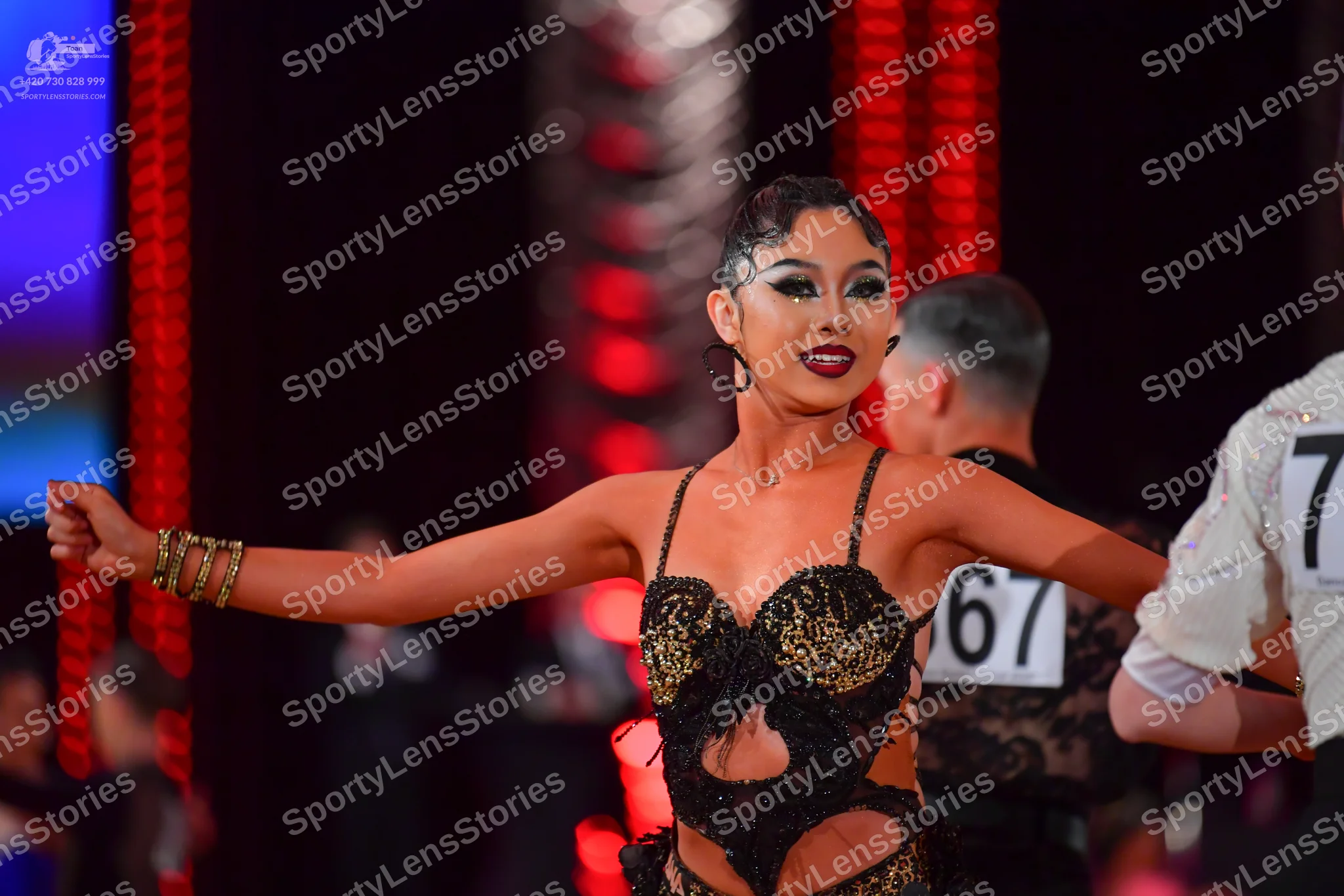 Dancesport competitor #67: Female dancer: black and gold sequined Latin dress with cutouts and thin straps
