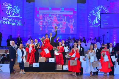 Dancesport competitor: Female dancers: various vibrant red ballroom or latin dresses made of satin or l