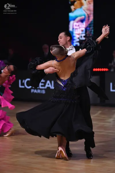 Dancesport competitor: Male dancer: black suit with a white shirt
