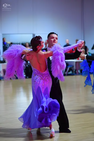 Dancesport competitor: Male dancer: black suit with a white shirt