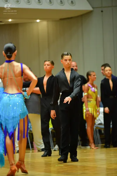 Dancesport competitor: Male dancers: black dance shirts, some with open chests, and black trousers
