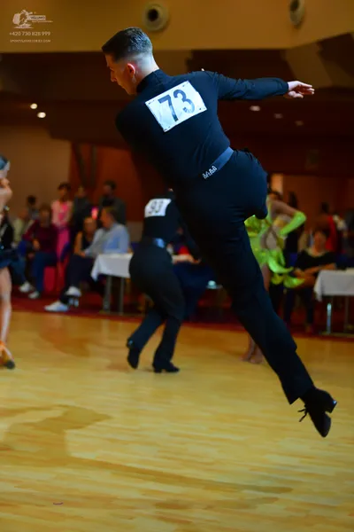 Dancesport competitor #73, #93: Male dancers: black long-sleeved shirts and black trousers