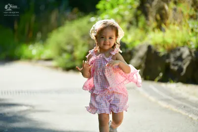 Dancesport competitor: Female dancer: pink and white gingham pattern ruffled outfit with a white lace-e