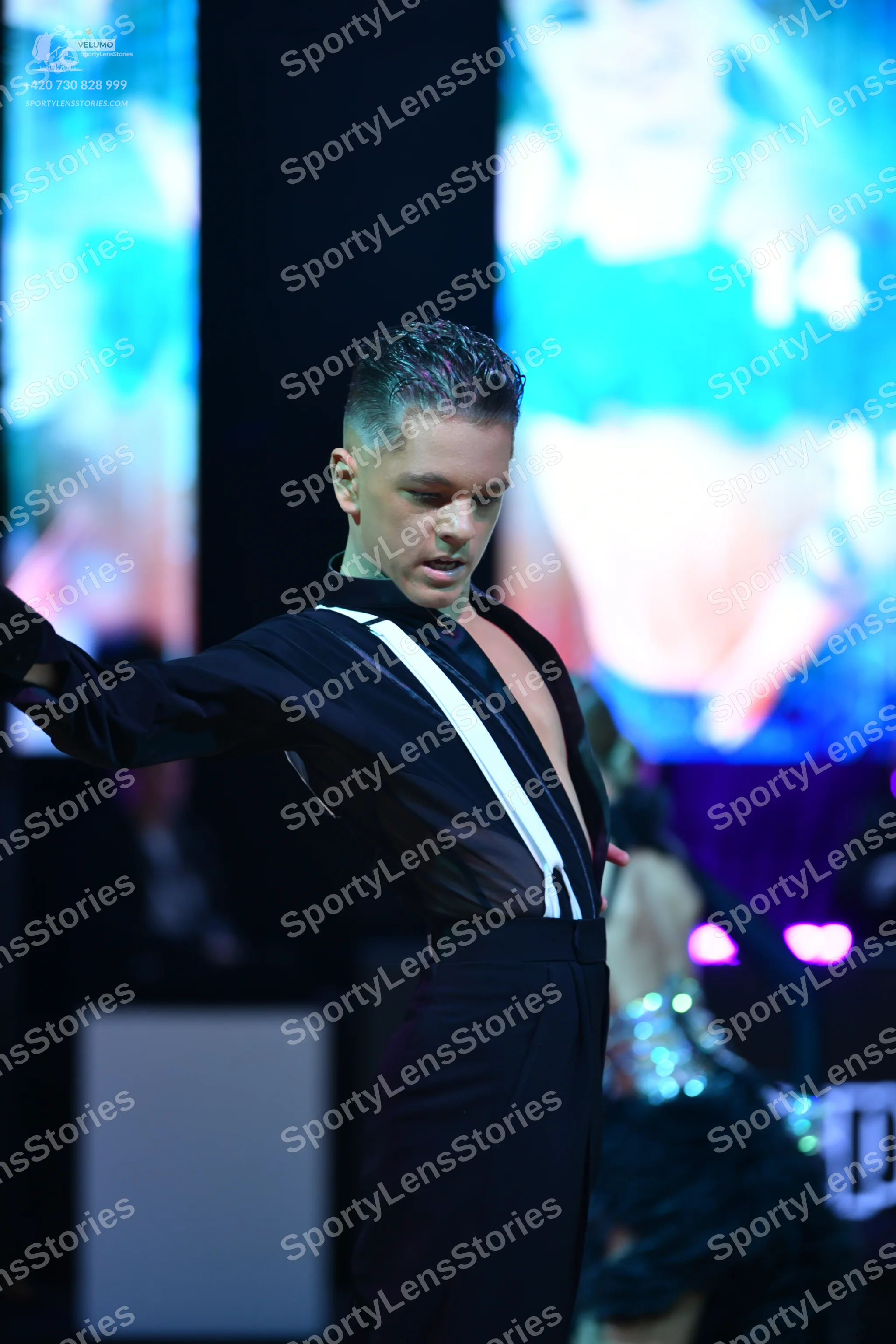 Dancesport competitor: Male dancer: black long-sleeved shirt with a white diagonal stripe detail