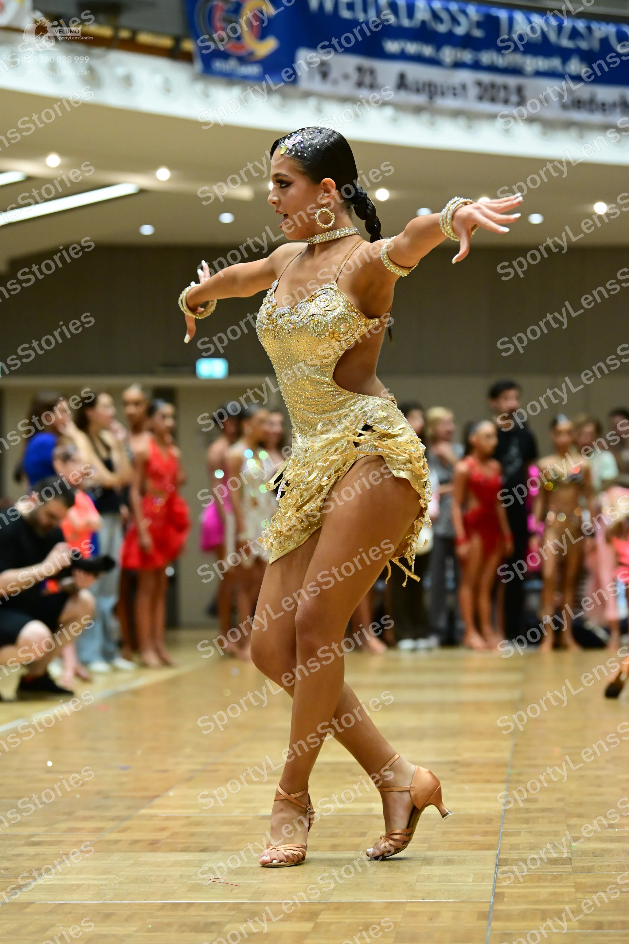 Dancesport competitor: Main dancer: gold/champagne-colored sequined Latin dress with side cutouts and f