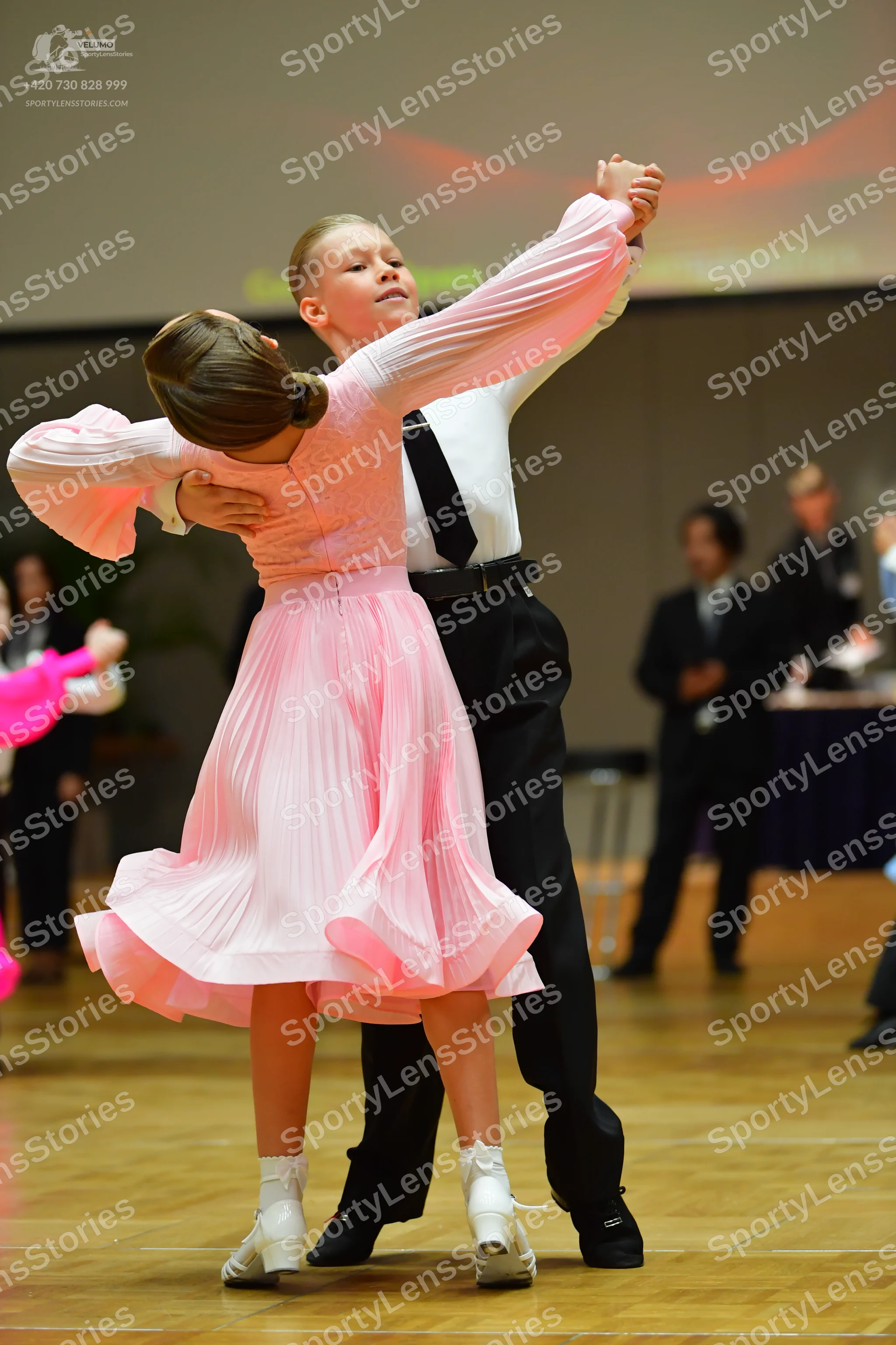 Dancesport competitor: Female dancer: light pink long-sleeved dress with a pleated skirt