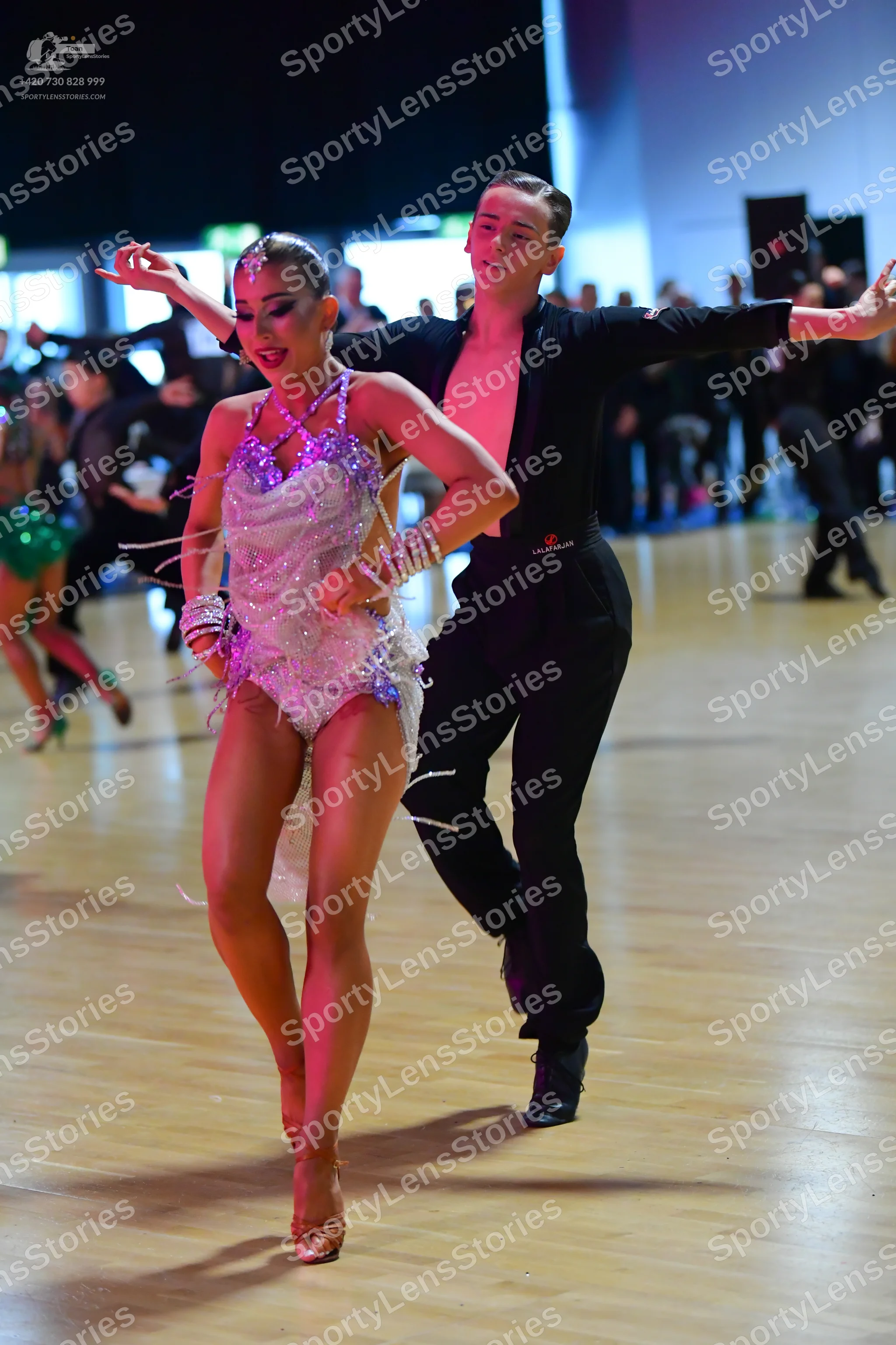 Dancesport competitor: Female dancer: light pink/lavender sequined Latin dress with long, thin, sparkli