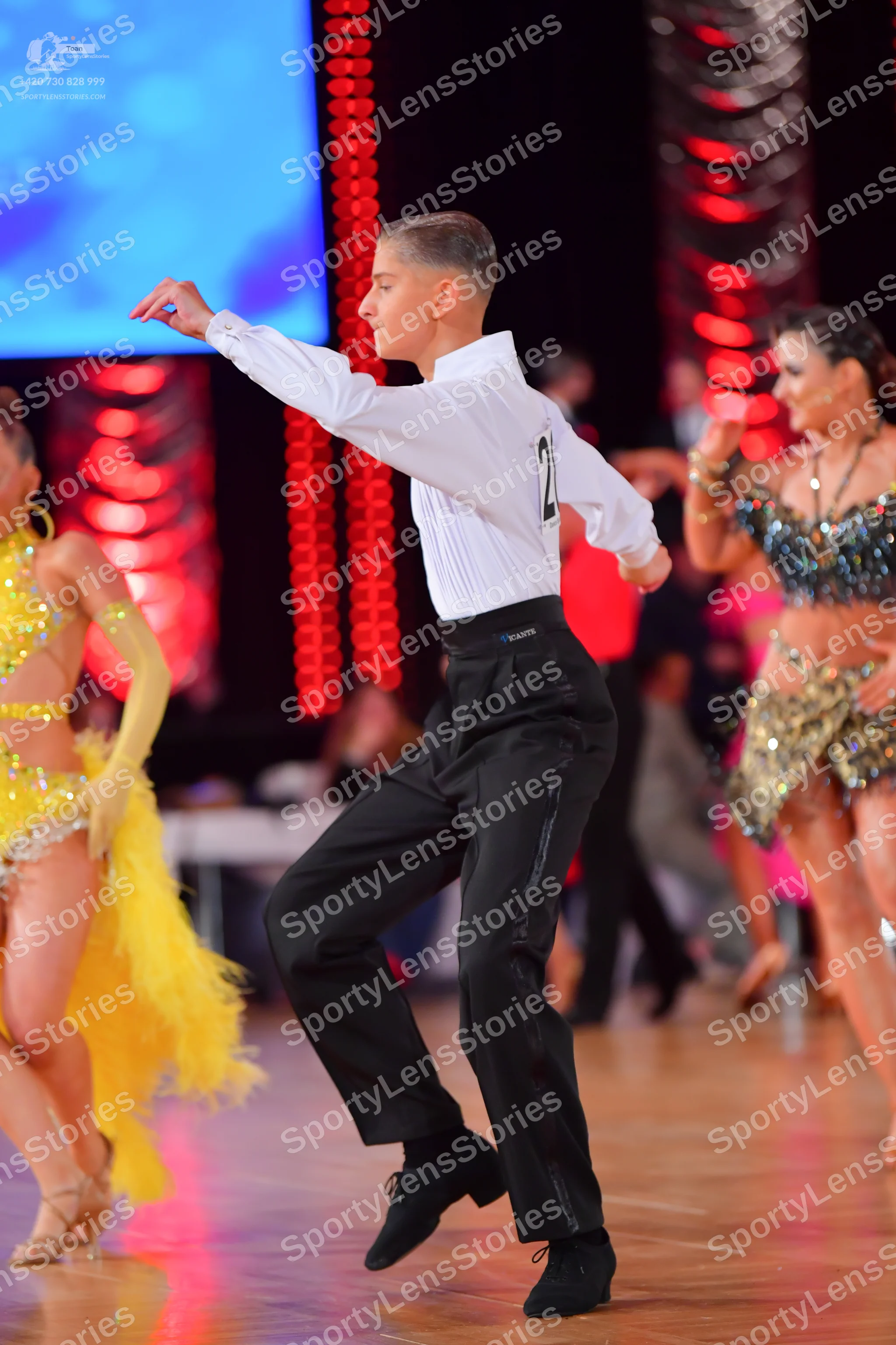 Dancesport competitor: Male dancer: white long-sleeved shirt and black trousers