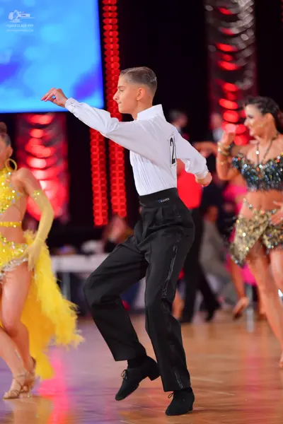 Dancesport competitor: Male dancer: white long-sleeved shirt and black trousers