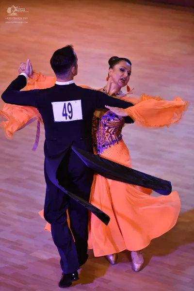 Dancesport competitor #49: Male:** Black tail suit with a subtle sheen (likely satin or satin-blend) with s