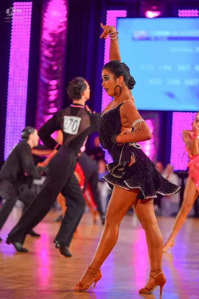 Dancesport competitor #270: Male dancer: black long-sleeved top with a mesh back panel and black trousers