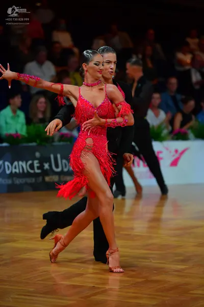 Dancesport competitor: Female dancer: red Latin dance dress with sequins and fringe