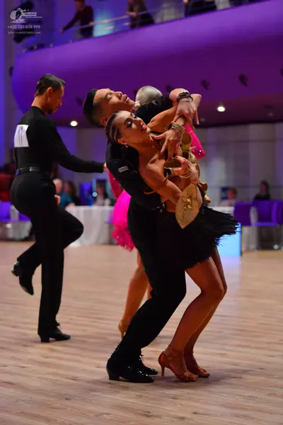 Dancesport competitor: Male dancers: black long-sleeved shirts and black trousers