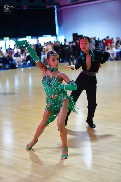 Dancesport competitor: Male dancer: black latin dance shirt and trousers with green accents